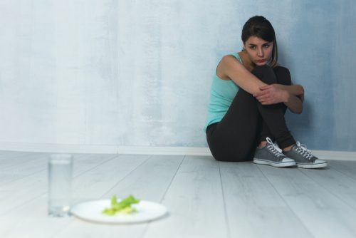 girl in corner afraid to eat even lettuce and water
