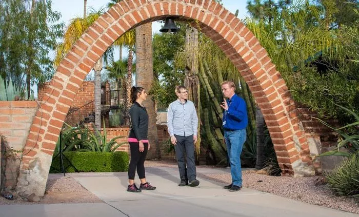 3 people taking under brick arch - Cottonwood Tucson holistic treatment for mood disorders and addiction - photo tour