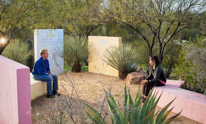 two people talking in desert courtyard - Cottonwood Tucson holistic treatment for mood disorders and addiction