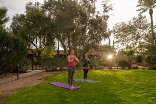 two women doing yoga outdoors - Cottonwood Tucson